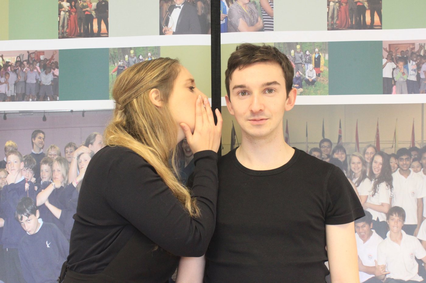 A workshop participant speaking quietly to another person who is listening