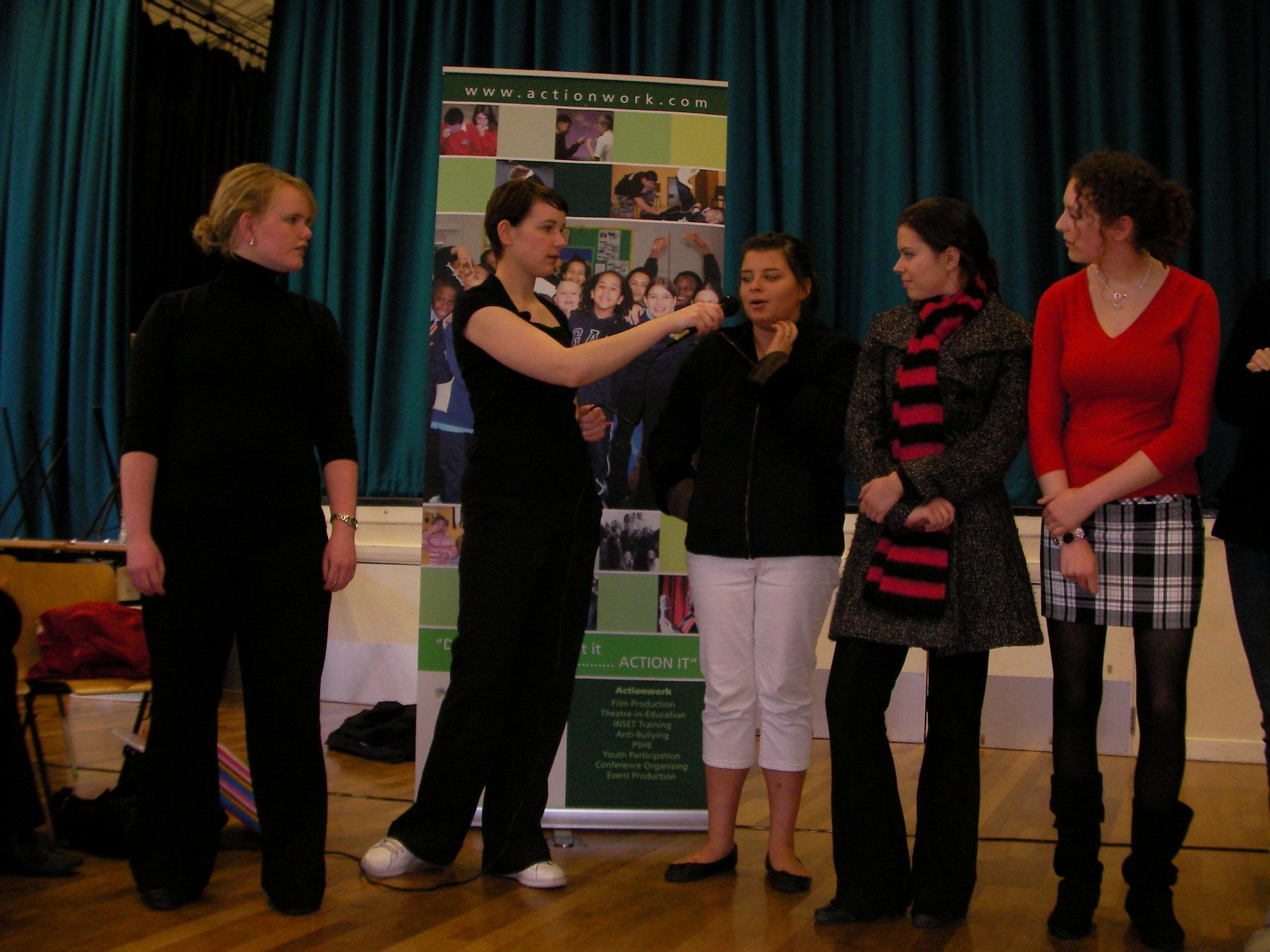 Young people speaking together during an anti bullying session, with one young person holding the microphone