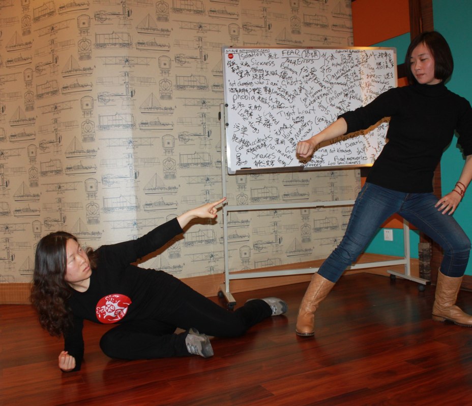 Two participants exploring bullying-related words in English and Chinese during an international workshop