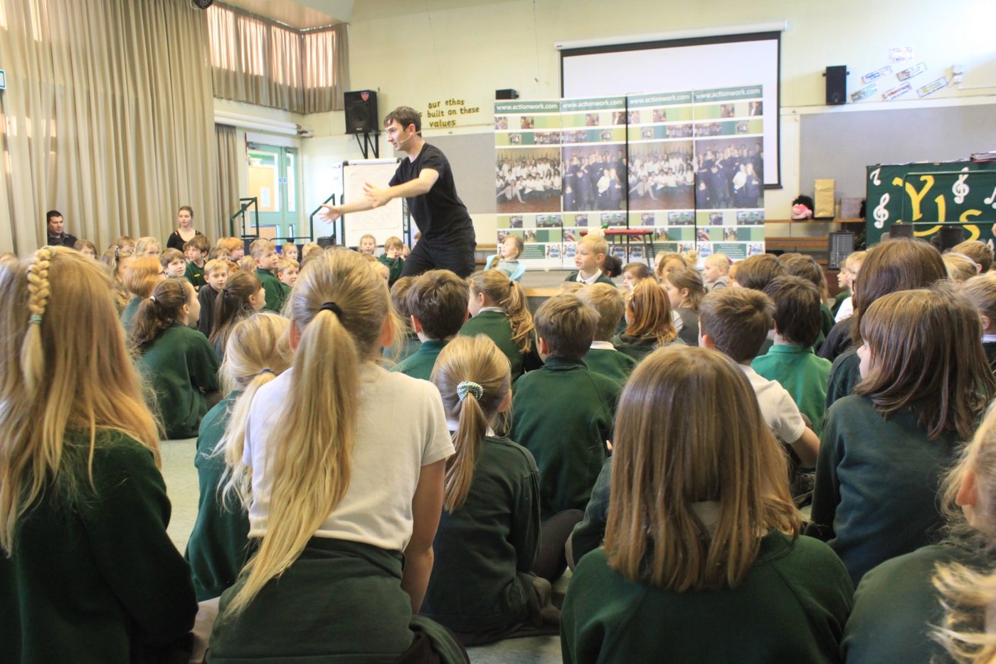 A facilitator working with a large school group